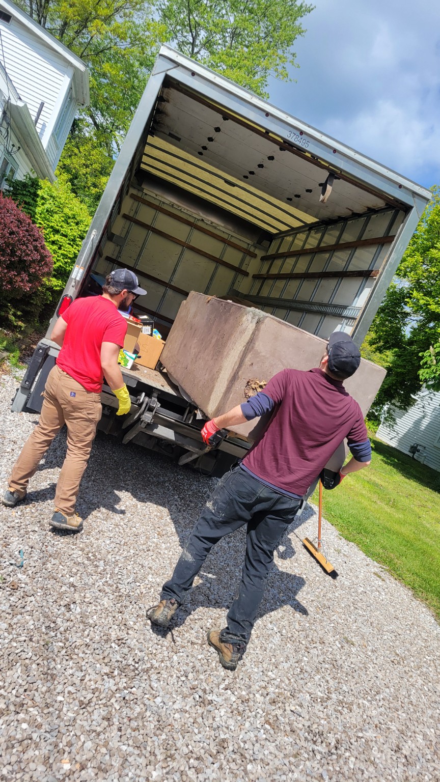 Big Barn crew loading a large item into the junk removal truck