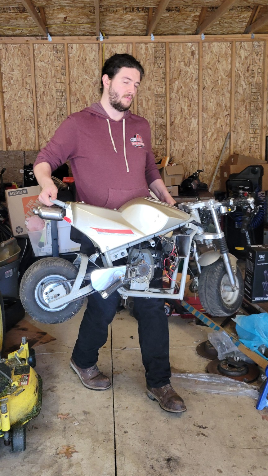 Big Barn removing a small motorcycle from a garage